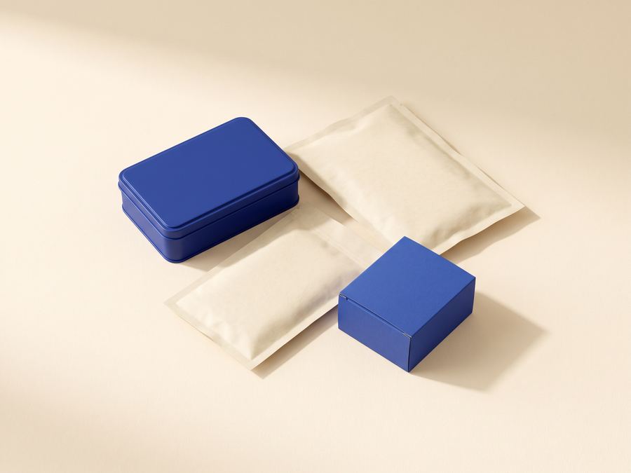 Cobalt-blue tins and cream pouches of edibles on a cream background