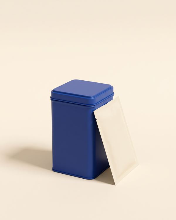 A cobalt-blue tin and a cream pouch of edibles
